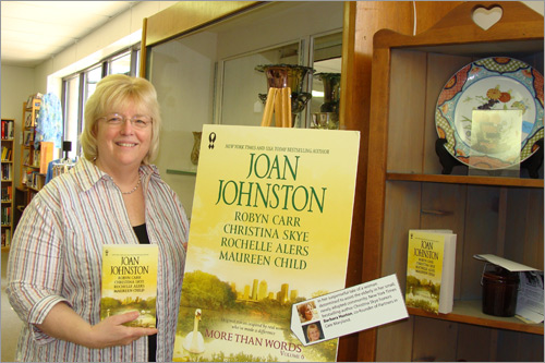 Barbara Huston poses with copies of More Than Words Volume 6