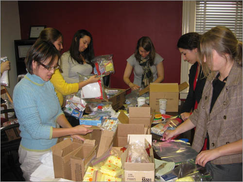 Volunteers assembling gift bags for some of the women Polaris Project helps.