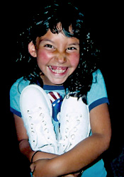 A little girl holding a pair of white sneakers