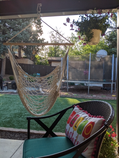 a hammock on a backyard porch