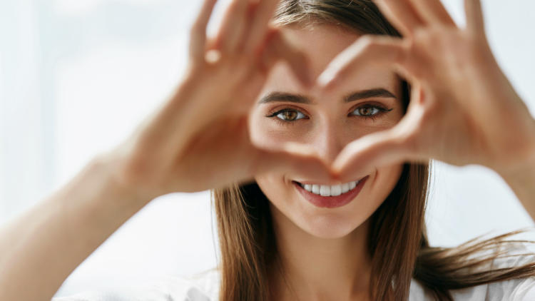 Woman making heart with her fingers