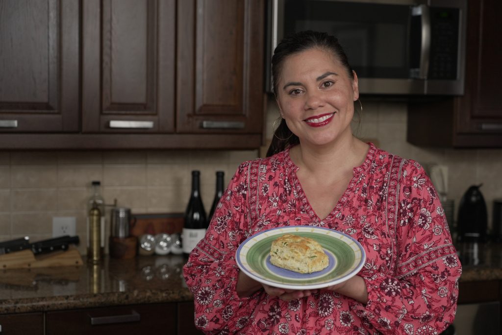 Angelina M. Lopez holding biscuit on plate