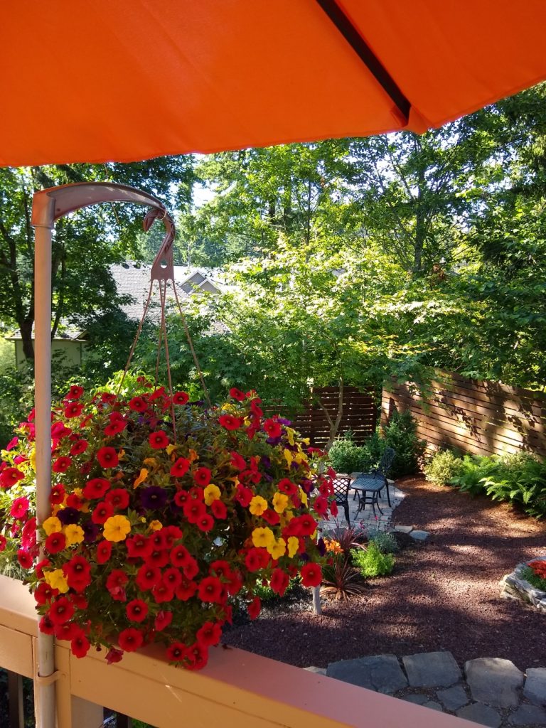 Christine Rimmer's deck with flowers and an orange umbrella