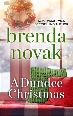 book cover image for A Dundee Christmas by Brenda Novak featuring a Christmas wreath hanging over a read and great couch