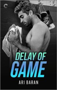 Cover image for Delay of Game by Ari Baran, featuring a black and white photo of a shirtless man holding a towel in a hockey locker room. There are a pair of black skates hanging on a hook on the wall behind him.