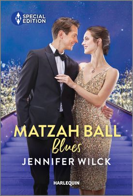 Cover image for Matzah Ball Blues by Jennifer Wilck, featuring a man and woman on an ornate staircase. The woman is in a sparkling dress and has her hand on the man's chest. The man is wearing a tuxedo. They are looking into each other's eyes.