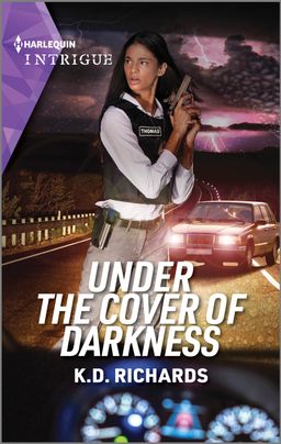 Cover image for Under the Cover of Darkness by K.D. Richards, featuring a woman in a bullet proof vest holding a gun. She is looking over her shoulder. Behind her is a stretch of highway with a car pulled over. The car's lights are on. It is night.