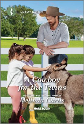 Cover image for A Cowboy for the Twins by Melinda Curtis, featuring a man in a cowboy hat watching twin girls pet a baby donkey. The field they are in is surrounded by a wooden fence.