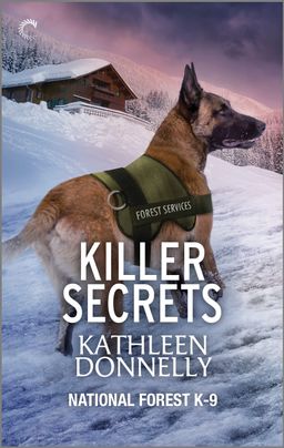 Cover image for Killer Secrets by Kathleen Donnelly, featuring a dog in a forest services vest running through a thick layer of snow. Behind the dog is a cabin also covered in snow.