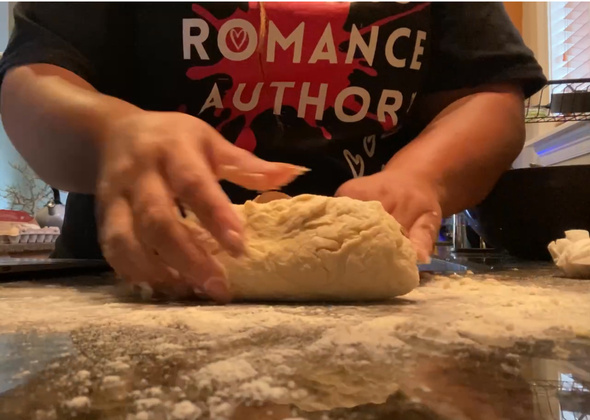 And image of hands kneading dough on a countertop