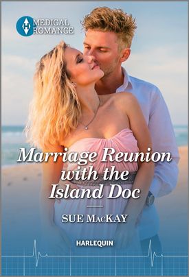 Cover image for Marriage Reunion with the Island Doc by Sue MacKay, featuring a man and a woman standing on a sunny beach. The man is standing behind the woman with his arms around her and is kissing her cheek.
