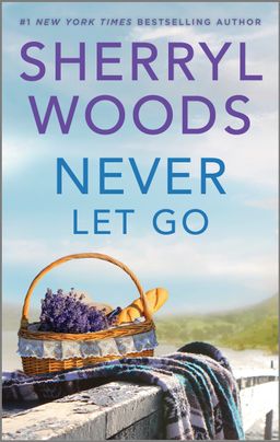Cover image for Never Let Go by Sherryl Woods, featuring a basket on a rock, filled with a loaf of bread and purple flowers. Int he background is a lake and trees.