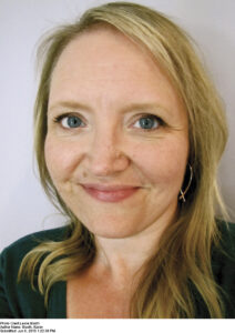 Image of author Karen Booth, a blonde woman in a black shirt.