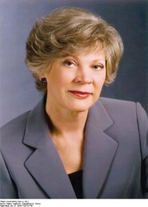 Image of author Karen Harper, a woman with short, light hair and wearing a grey suit.