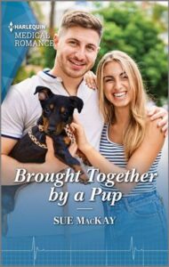 Cover image for Brought Together by a Pup by Sue MacKay, featuring a man and a woman with their arms around each other's shoulders. The man is holding a puppy in his free hand.