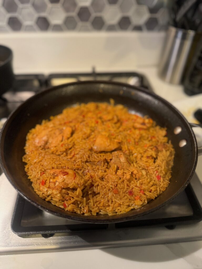 An image of chicken and rice on a stove