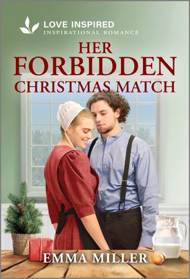 Cover image for HER FORBIDDEN CHRISTMAS MATCH by Emma Miller, featuring an amish man and woman indoors standing by a table. On the table is a pitcher of water and a small pine tree in a planter.