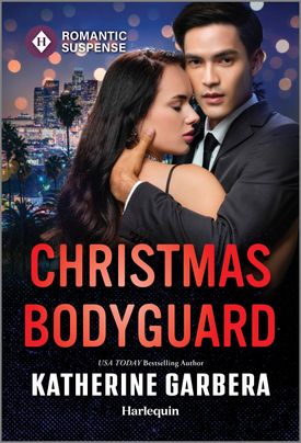 Cover image for Christmas Bodyguard by Katherine Garbera, featuring a man and a woman embracing. It is outdoors and night time. There is a cityscape in the background.