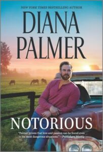 Cover image for NOTORIOUS by Diana Palmer, featuring a man leaning against the hood of a truck. In the background, there are horses grazing in a field.